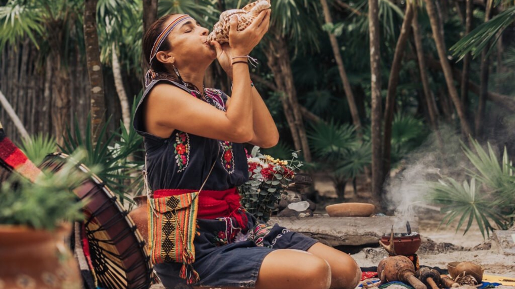 Native,Woman,In,Traditional,Clothes,Playing,Music,With,White,Shell