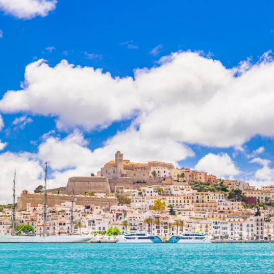 An extremely detailed view of Eivissa's old town centre and marina, bright sky, picturesque clouds, a moored sailing ship, the iconic skyline of Dalt Vila dominated by the cathedral church of Santa Maria de les Neus. Developed from RAW.